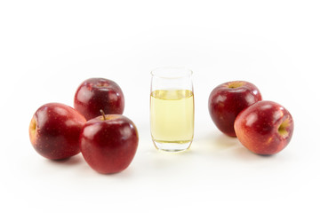 five apples and a glass of apple juice