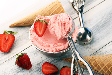 Strawberry ice cream scoop on a rustic white background with fresh strawberries