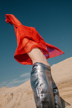 Anonymous model in strange clothes dancing under sun