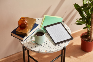 Ebook on table with cup of coffee.