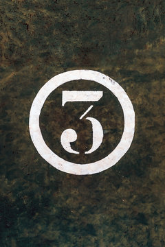 Number 3 Printed on White Over Grunge Wall