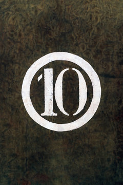 Number 10 Printed on White Over Grunge Wall