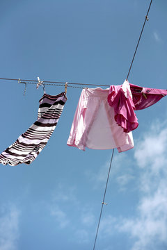Urban clothesline high up in the sky, messed up by the wind