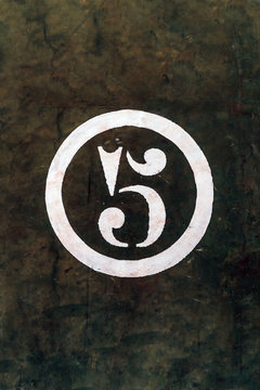 Number 5 Printed on White Over Grunge Wall