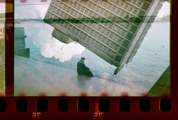 Collage multi-exposure - a man on the river bank of a big city