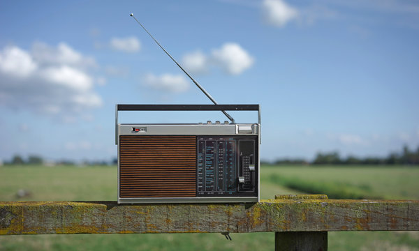 old transistor radio playing on the countryside