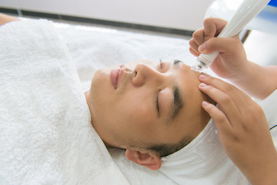 Man Receiving Facial Treatment In Spa