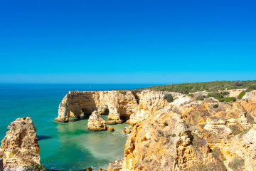 Fototapeta na wymiar Praia de Marinha most Iconic Beach and Popular Landmark in Lagoa, Algarve Portuga. Beautiful landscape on coast of Atlantic Ocean 