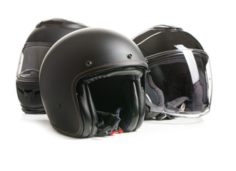Three black motorcyle helmets.