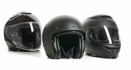 Three black motorcyle helmets.