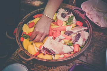 Lamb meat, potatoes and vegetables preparing for cooked on a grill, Serbian dish 