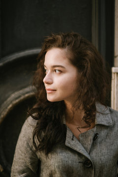 Portrait of a young beautiful woman walking in old town