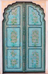 Fototapeta na wymiar Ancient green doorway in Hawa Mahal palace in Jaipur, India