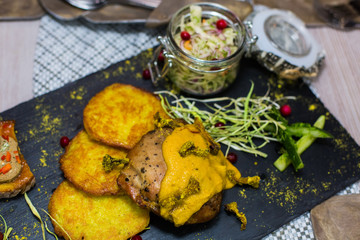 Delicious tasty fried potatoes and grilled meat with mushrooms