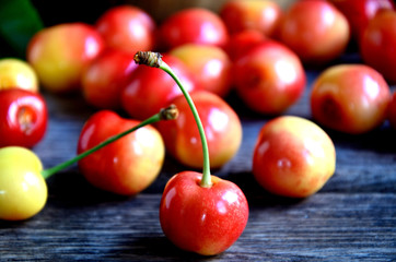 Cherry scattered on wooden boards.