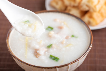 chinese congee on spoon close up image