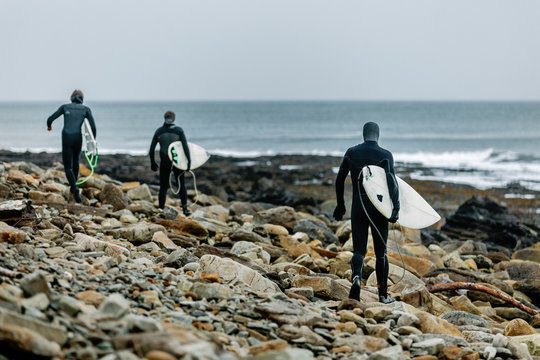 Winter Surfers Going into the water
