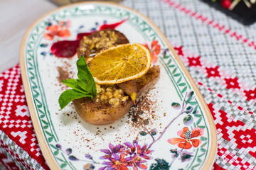 Sugar dessert wuth mint, lemon, nuts ant cooked peaches on beautiful plate. Food , menu concept