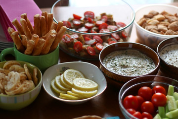 Table setting with galette, snacks, dips and salads. Selective focus.