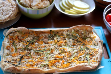 Table setting with galette, snacks, dips and salads. Selective focus.