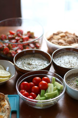 Table setting with galette, snacks, dips and salads. Selective focus.