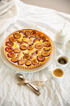 Plum custard tart served with coffee