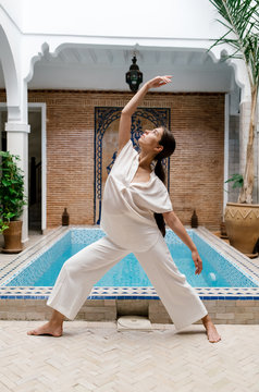 Woman practicing yoga in oriental patio