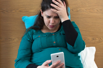 Expectant Young Mom Searching on Her Smartphone