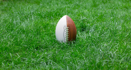american football ball on a sports lawn