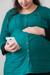Expectant Young Mom Searching on Her Smartphone