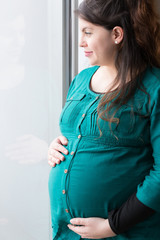 Smiling Expectant Mom Holding Her Budding Baby Bump