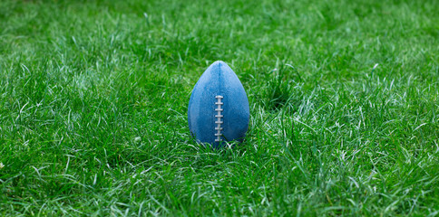 american football ball on a sports lawn