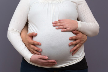 Expectant Parents Holding Growing Baby Bump