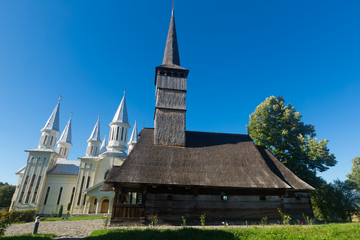 Fototapeta na wymiar Old and new edifices of church in Remetea Chioarului, Romania