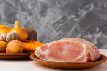 Raw pork tenderloin, ready to roast, with spices, black pepper, olive oil, garlic, bay leaf