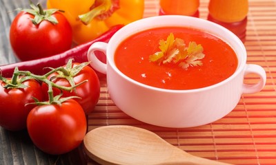 Bowl of gazpacho or tomato soup with ingredients