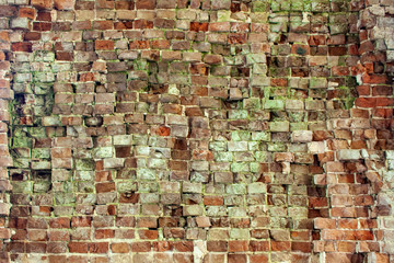 Fragments brick wall close-up. Fragment of the old brickwork. Potholes and red brick defects.