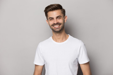 Attractive positive guy with snow-white smile looking at camera