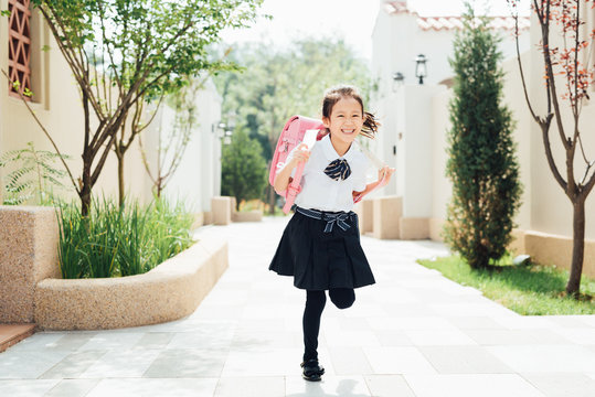 Adorable girl go to school with a backpack