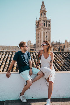 Two friends on a terrace overlooking the giralda