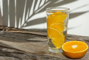 orange water with fresh fruit on wooden  background
