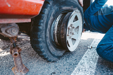 Man change the wheel manually on a 4x4 off road truck