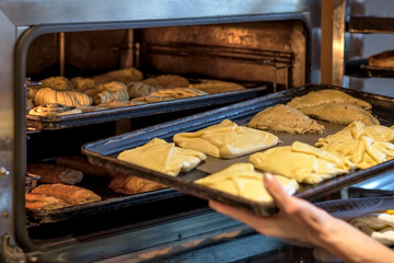 Ready to cook sweet pie in oven at small bakery.