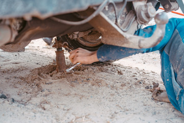 A man raises on a jack 4x4 off road truck