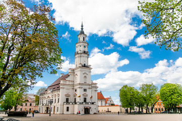 Fototapeta na wymiar Town Hall White Swan in the center of Kaunas at the Town Hall Square in Lithuania in the spring against a blue sky with cirrus clouds. Kaunas, Lithuania – May, 2019