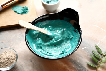 Bowl with cosmetic clay on table