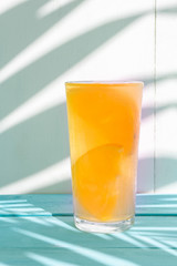 orange water with fresh fruit on colorful background