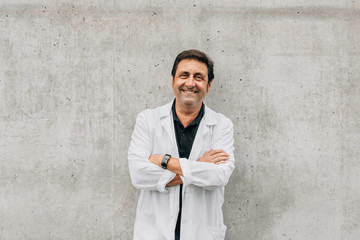 Portrait of happy confident doctor in the hospital corridor
