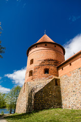 Fototapeta na wymiar Trakai Island Castle in Lithuania, Eastern Europe. Tourists visit city castle. Famous ancient landmark