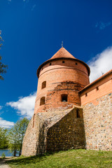 Obraz premium Trakai Island Castle in Lithuania, Eastern Europe. Tourists visit city castle. Famous ancient landmark